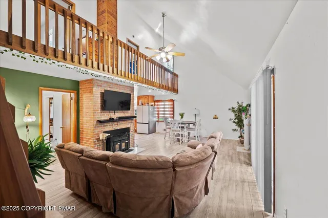 a living room with furniture a flat screen tv and a fireplace