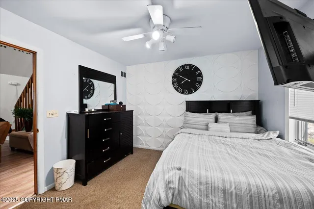 a bedroom with a bed and a mirror