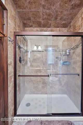 a bathroom with a glass shower door