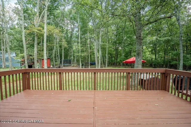 a view of balcony with wooden floor and fence