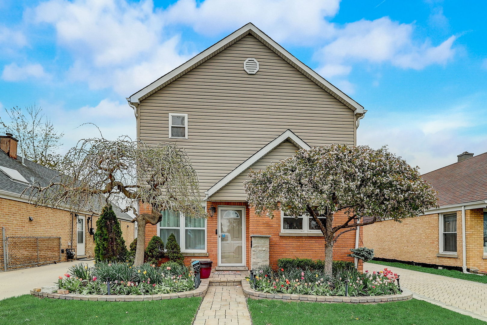 a front view of house with a garden