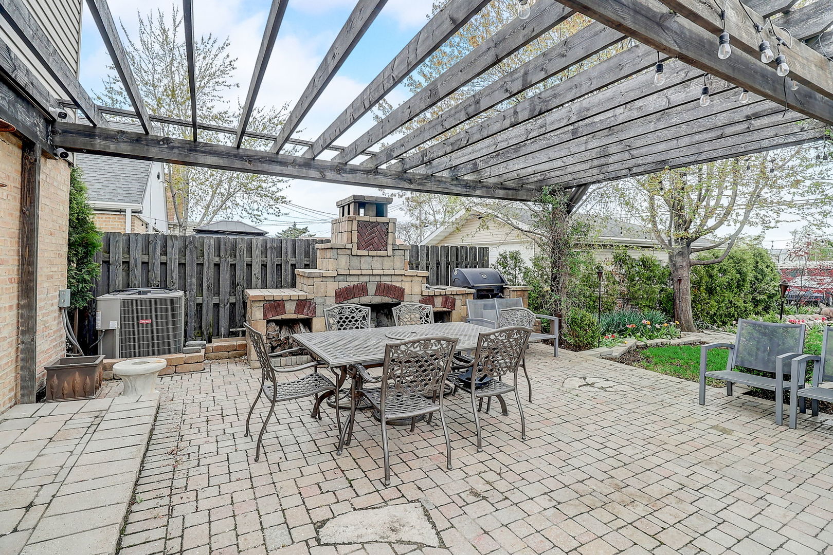4045 Ruby Street Schiller Park, IL 60176 - Photo 27 of 33 a view of a patio with table and chairs and couches with wooden roof and stairs