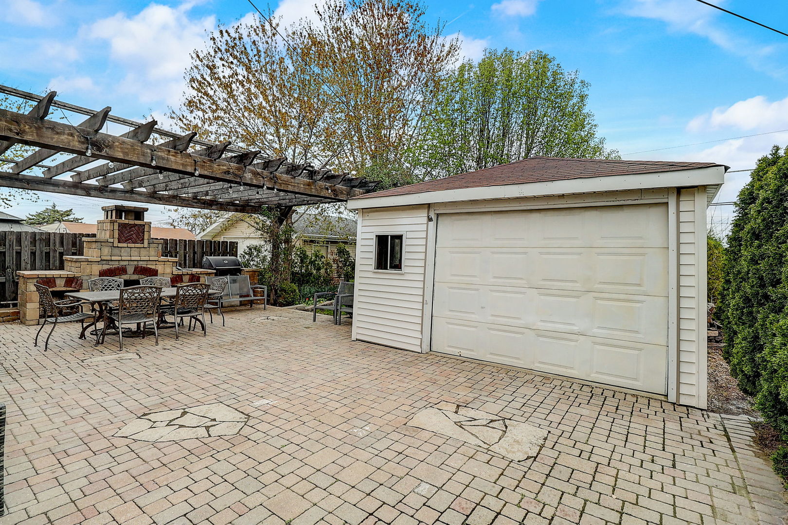 4045 Ruby Street Schiller Park, IL 60176 - Photo 28 of 33 a view of a backyard with table and chairs and a large tree
