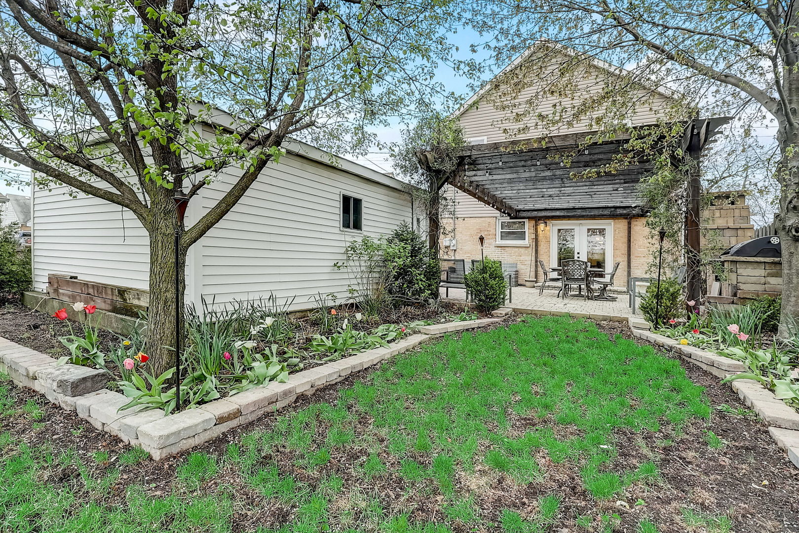 4045 Ruby Street Schiller Park, IL 60176 - Photo 29 of 33 a front view of a house with garden