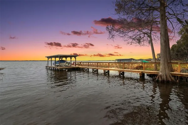 a view of a lake with a table under an umbrella