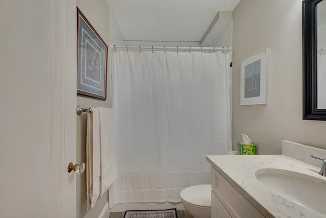 a view of living room filled with furniture and book shelf