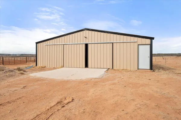 a living room with furniture and a kitchen view