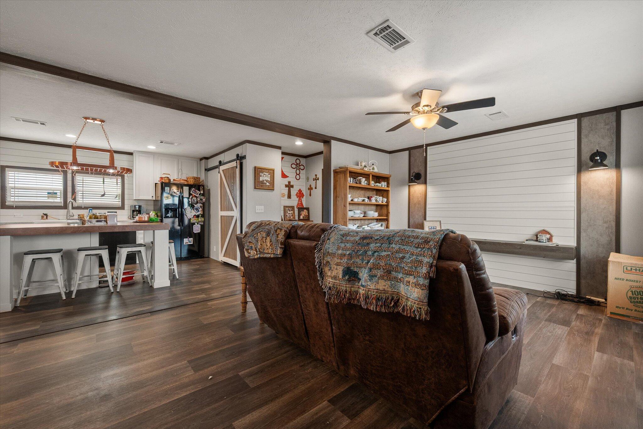 3013 West 15th Street Post, TX 79356 - Photo 42 of 71 a living room with furniture and a wooden floor