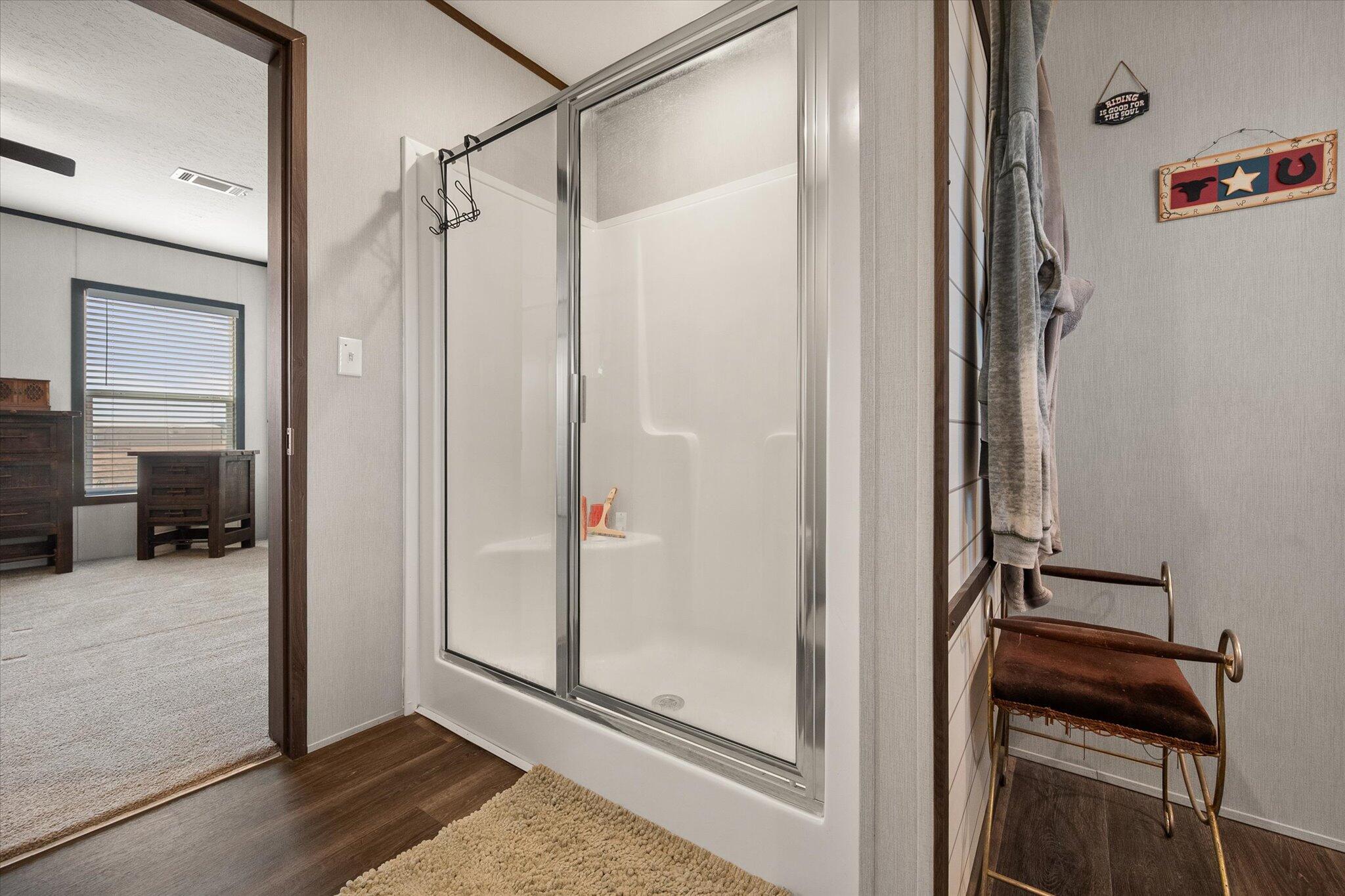 3013 West 15th Street Post, TX 79356 - Photo 59 of 71 a view of a bathroom with a glass shower door