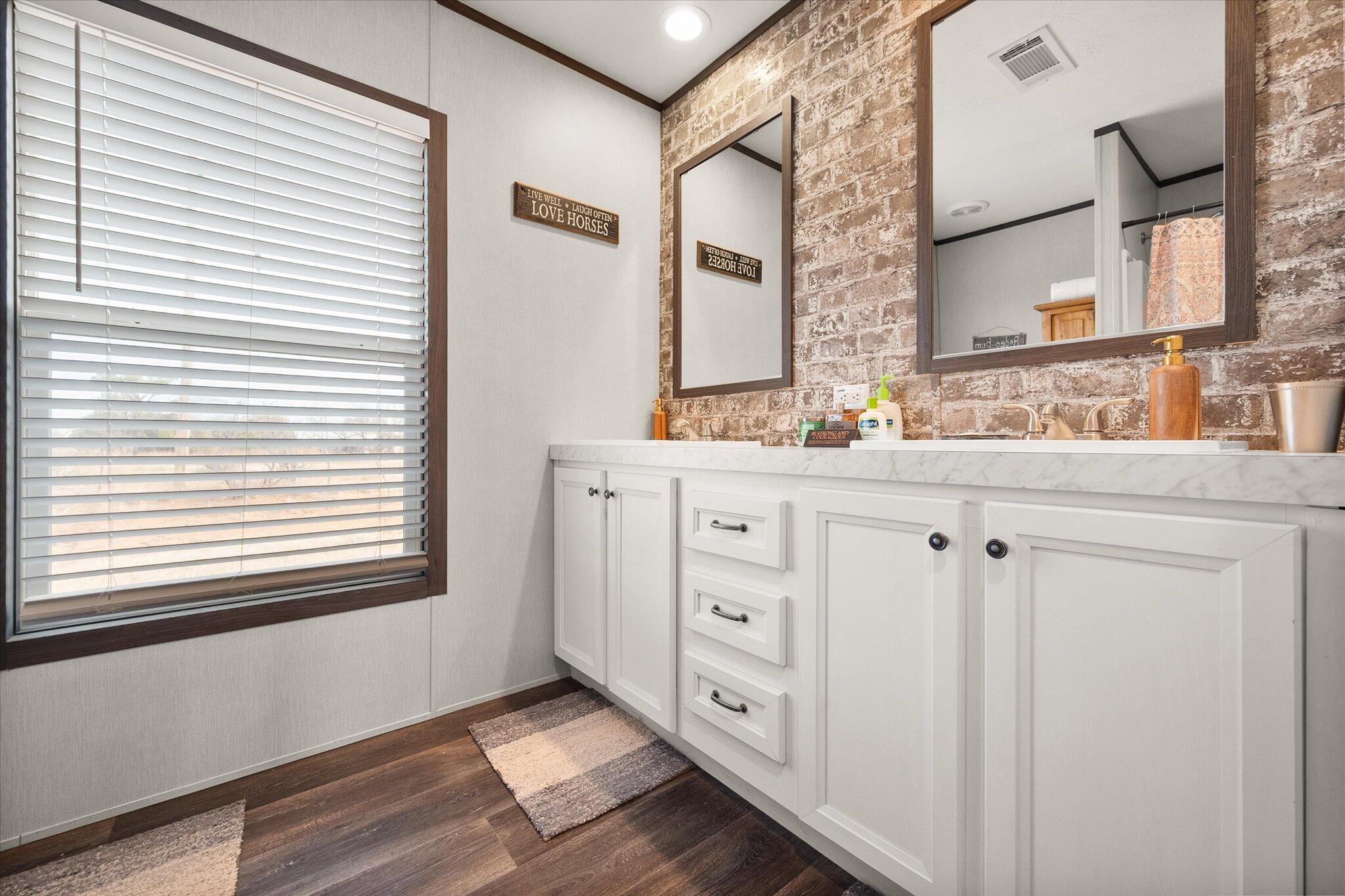 3013 West 15th Street Post, TX 79356 - Photo 61 of 71 a bathroom with a sink a mirror and a window