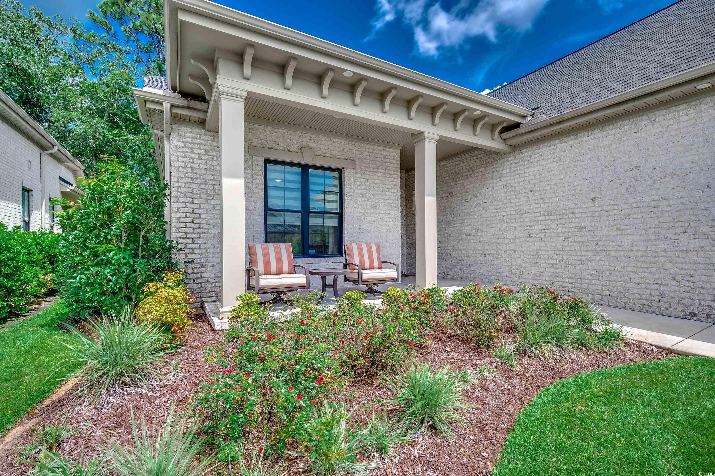 8404 Cape Dutch Loop Myrtle Beach, SC 29572 - Photo 3 of 40 View of exterior entry featuring brick siding and a shingled roof