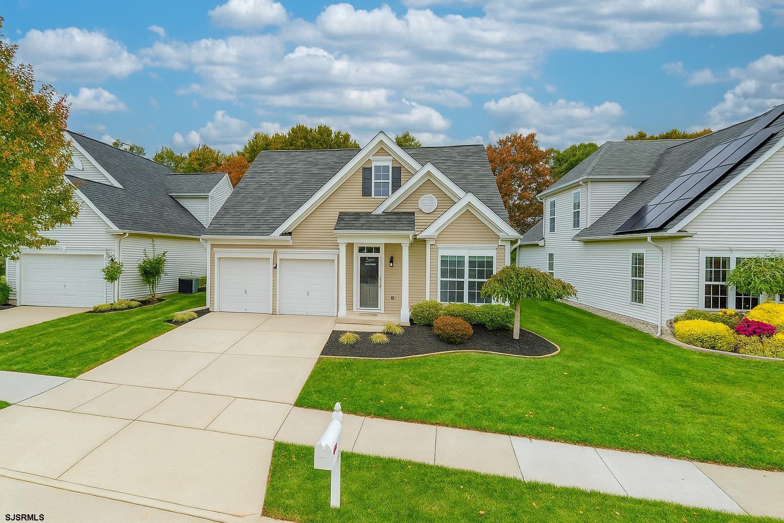 243 Lily Road Egg Harbor Township, NJ 08234 - Photo 1 of 29 a front view of a house with garden