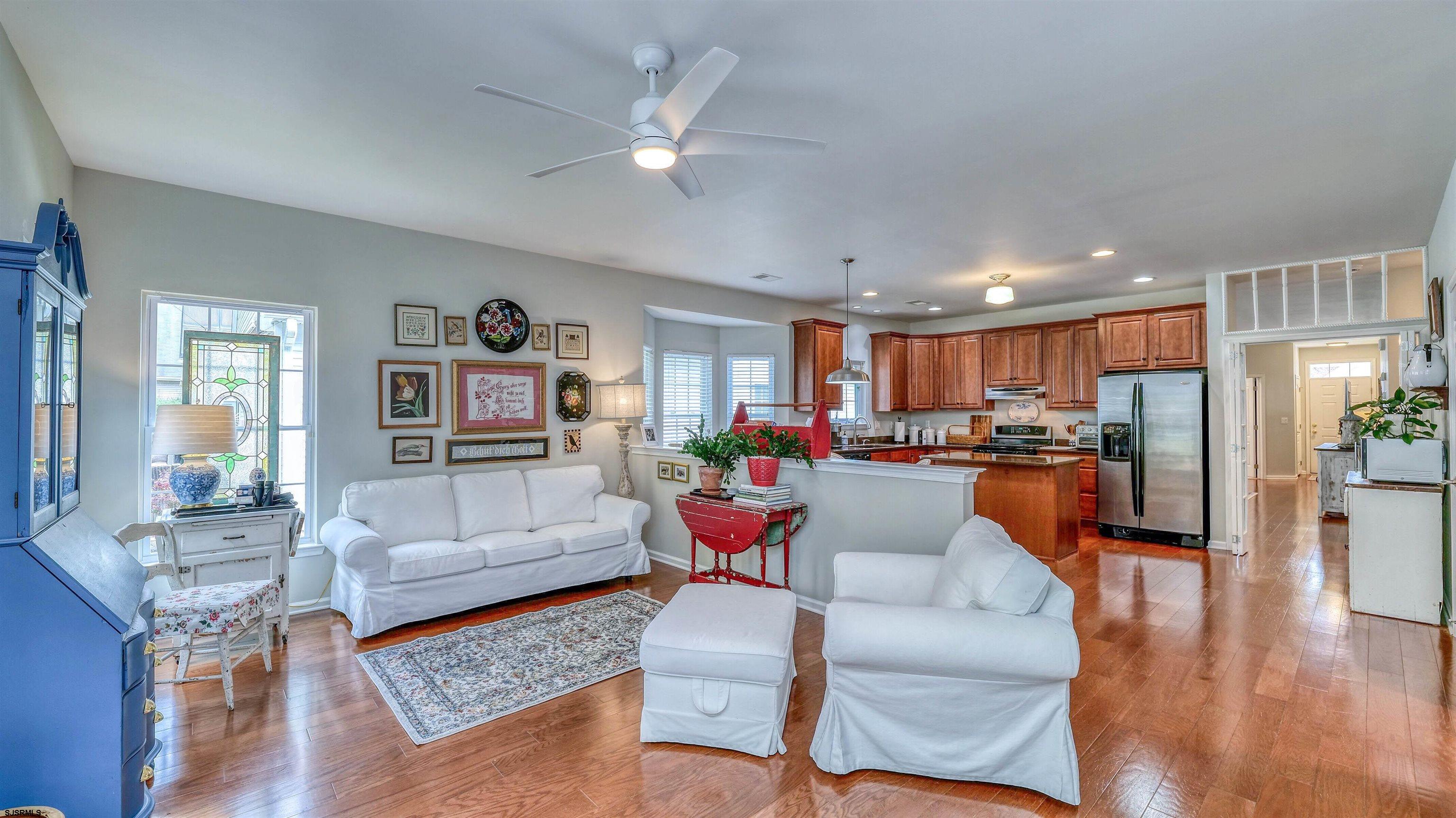 243 Lily Road Egg Harbor Township, NJ 08234 - Photo 11 of 29 a living room with furniture kitchen view and a wooden floor