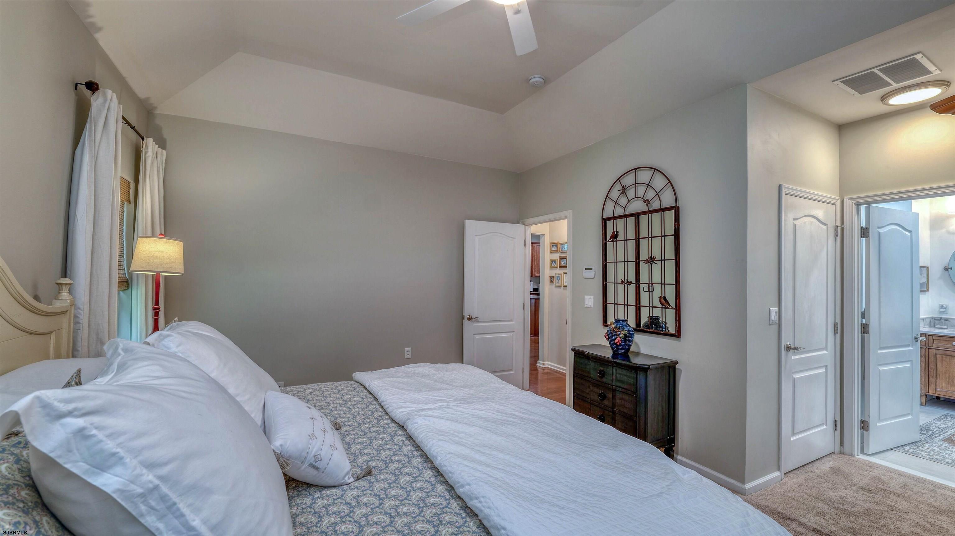 243 Lily Road Egg Harbor Township, NJ 08234 - Photo 15 of 29 a bedroom with a bed and a mirror