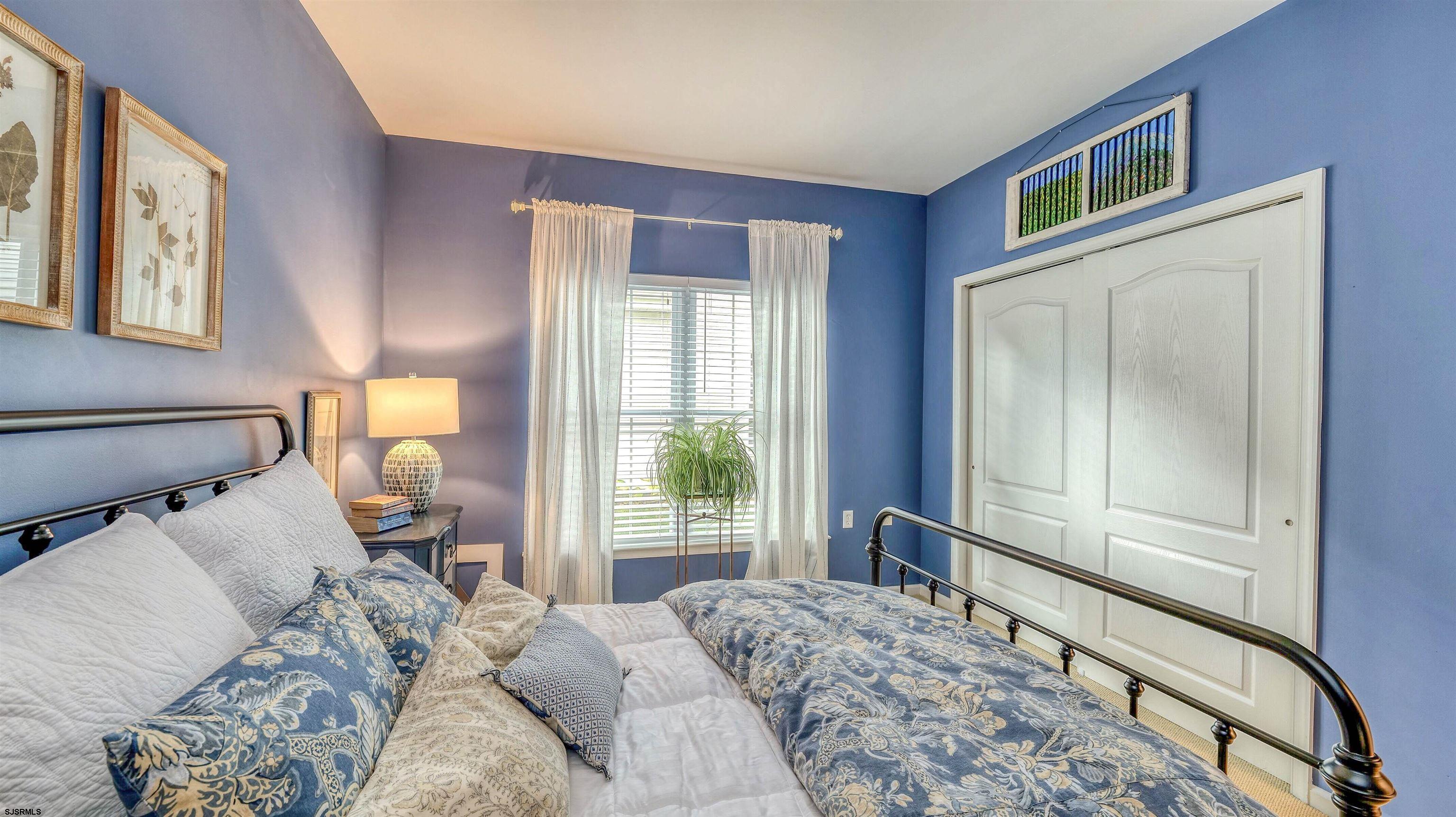 243 Lily Road Egg Harbor Township, NJ 08234 - Photo 22 of 29 a bedroom with a bed and large windows