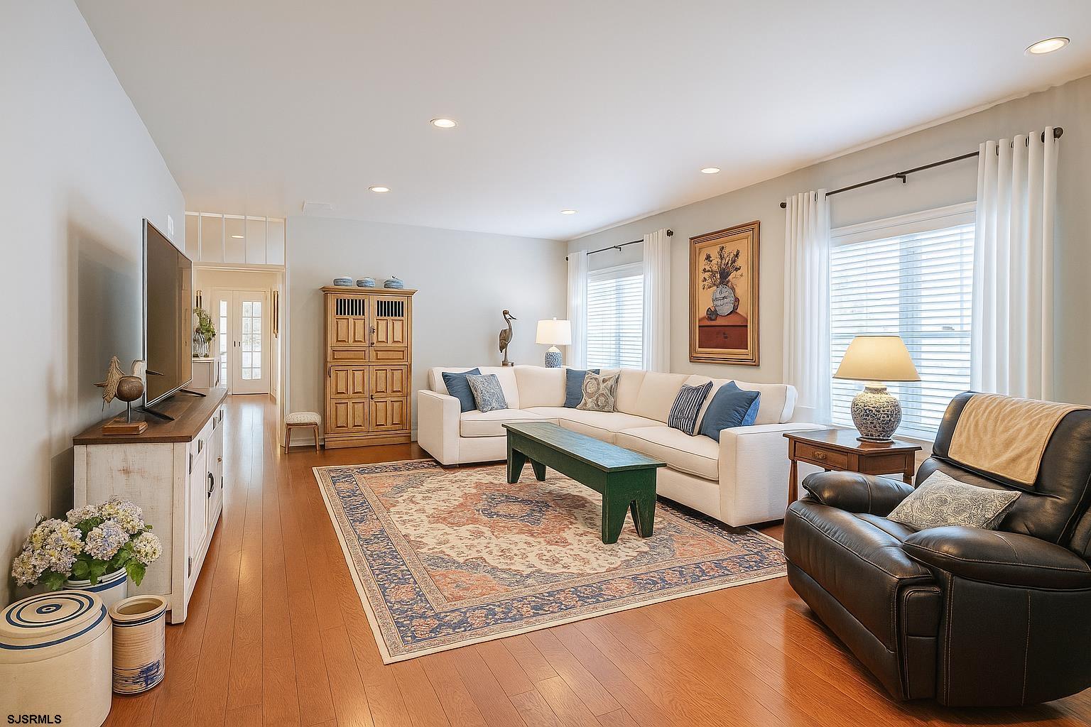243 Lily Road Egg Harbor Township, NJ 08234 - Photo 3 of 29 a living room with furniture and a flat screen tv