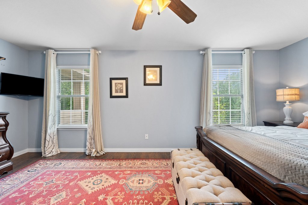 140 Wolfberry Path Buda, TX 78610 - Photo 22 of 35 a bedroom with a bed and a window