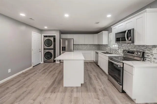 a kitchen with a stove top oven sink and cabinets