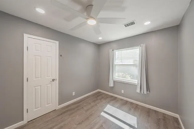 an empty room with windows and closet