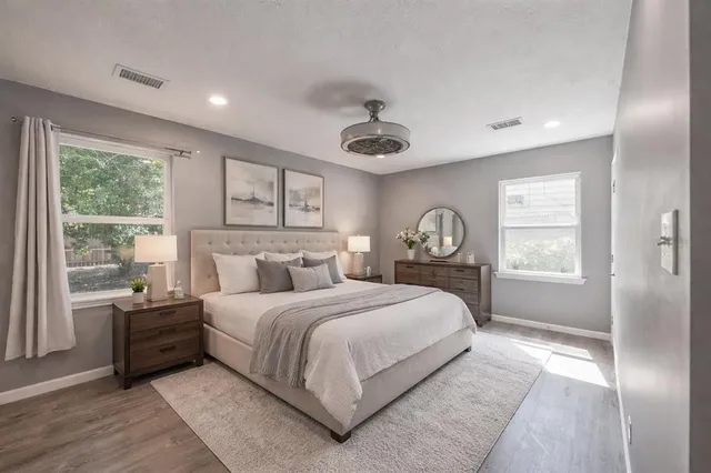 a bedroom with a large bed and a large window