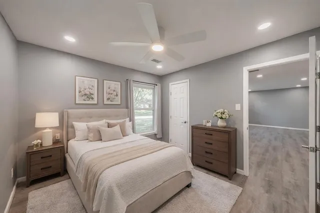 a bedroom with a large bed and a dresser