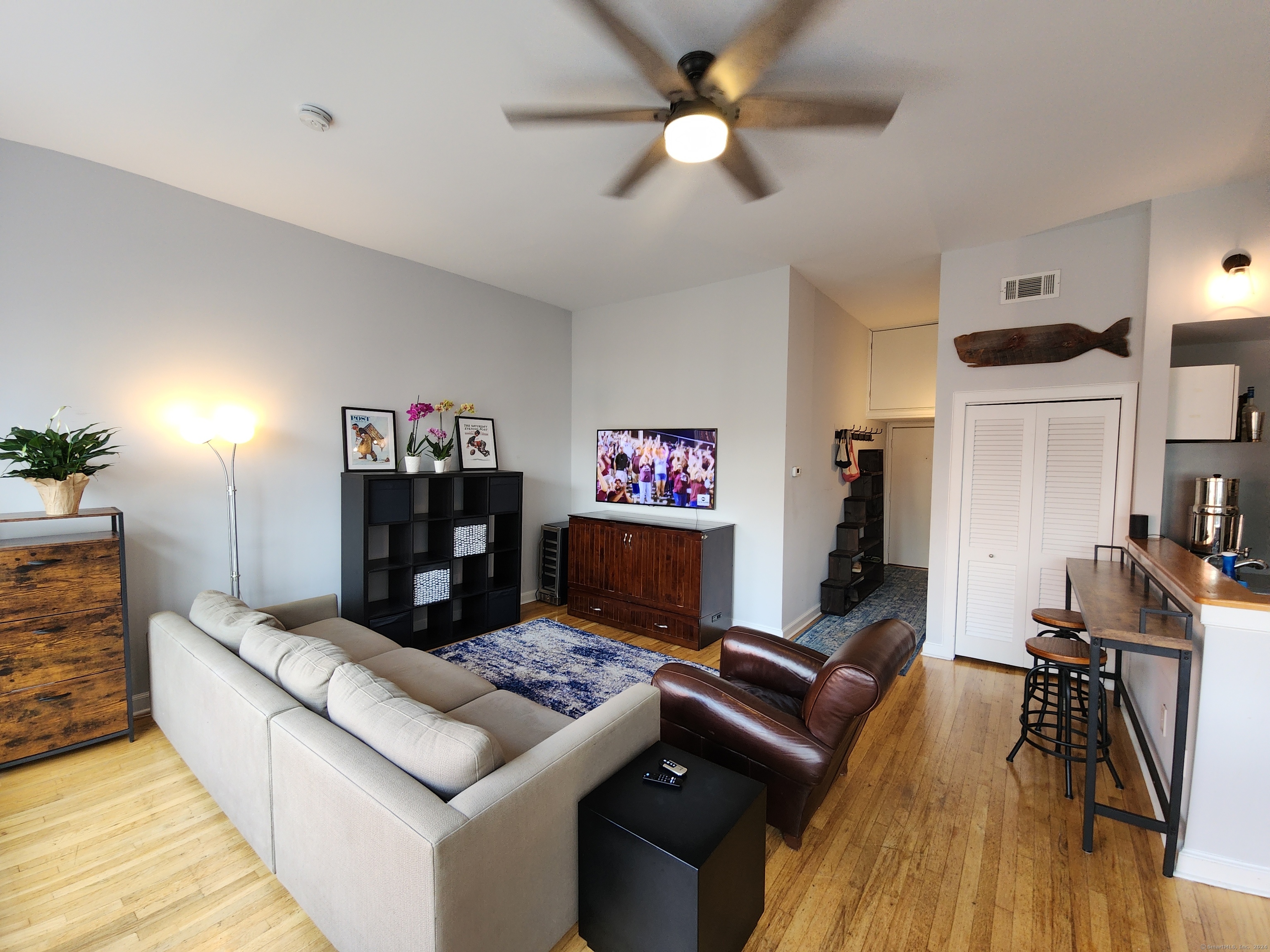 2 South Main Street, Unit W201 Norwalk, CT 06854 - Photo 2 of 10 a living room with furniture and a wooden floor