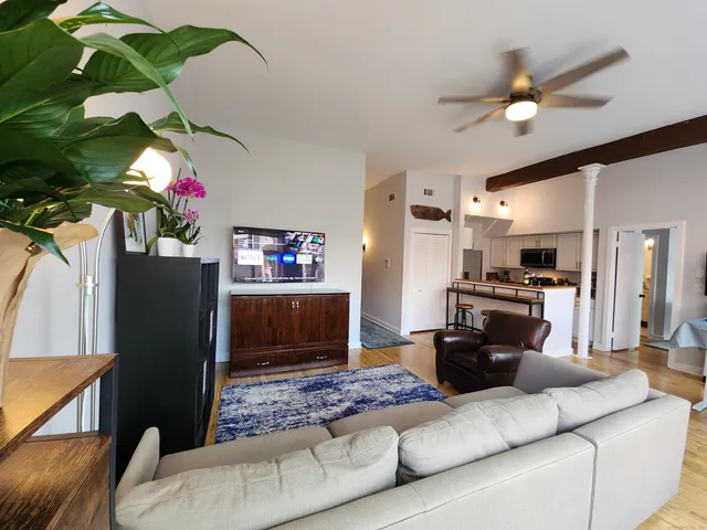 a living room with furniture and a flat screen tv