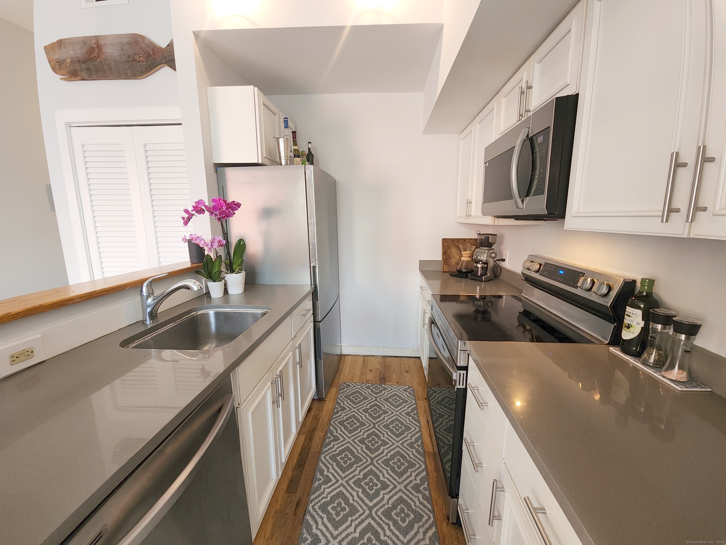 2 South Main Street, Unit W201 Norwalk, CT 06854 - Photo 6 of 10 a kitchen with a sink stove top oven and microwave
