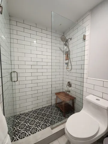 a bathroom with a toilet and shower
