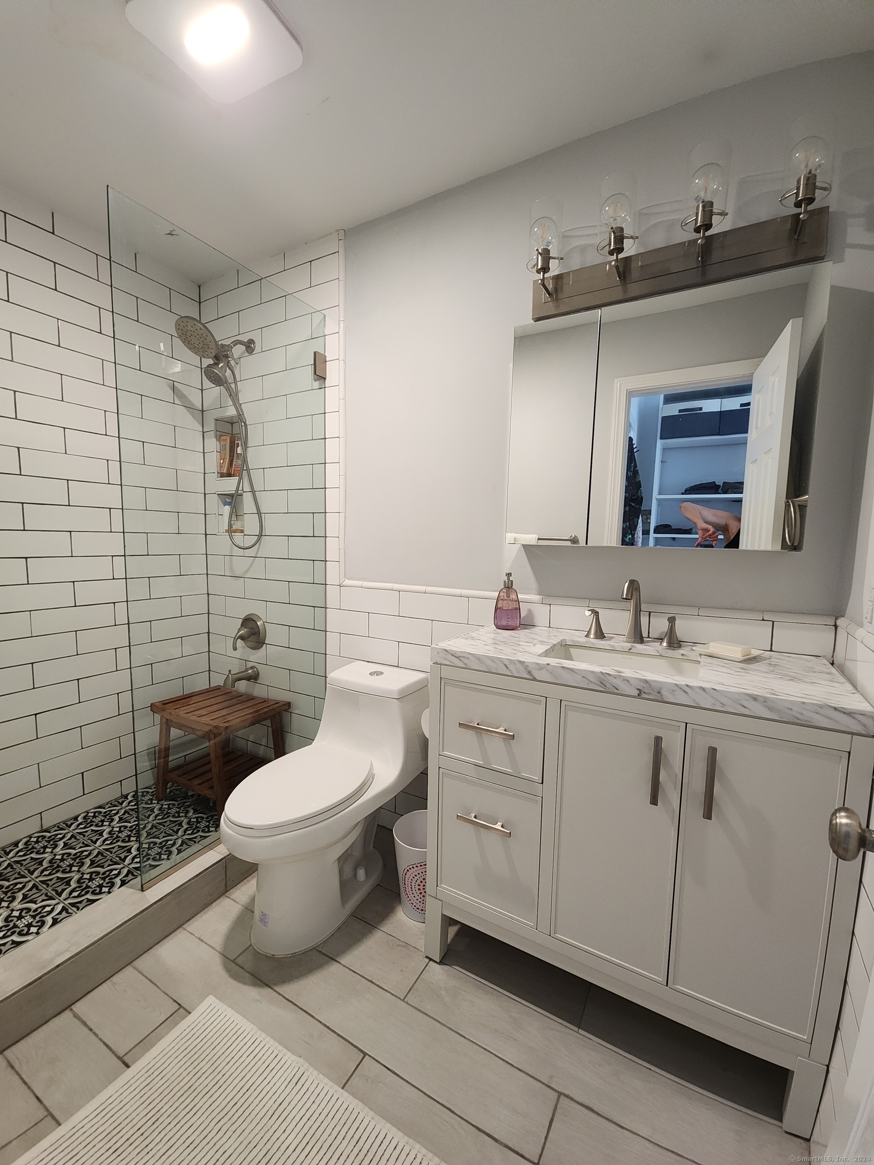 2 South Main Street, Unit W201 Norwalk, CT 06854 - Photo 8 of 10 a bathroom with a double vanity sink mirror and toilet