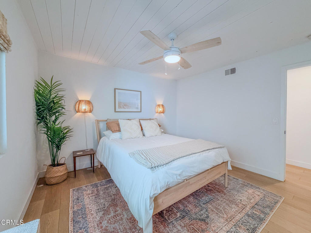 4954 Dolphin Way Oxnard, CA 93035 - Photo 18 of 40 a bedroom with bed and a potted plant