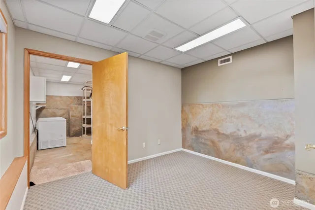 a view of a livingroom with furniture and an entryway