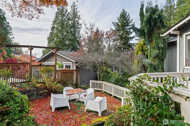 a view of a house with backyard sitting area and garden