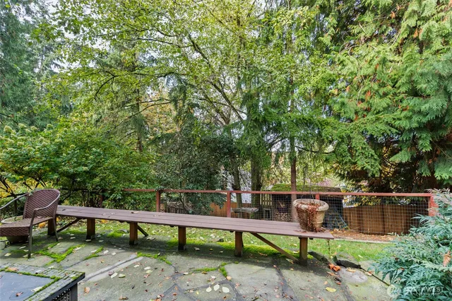 a view of a chairs and table on the garden
