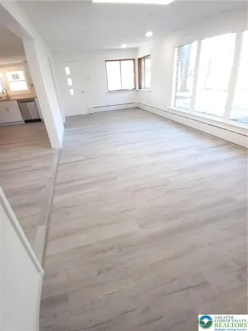 a view of an empty room and a window