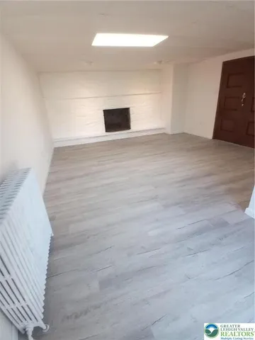 a view of an empty room and wooden floor
