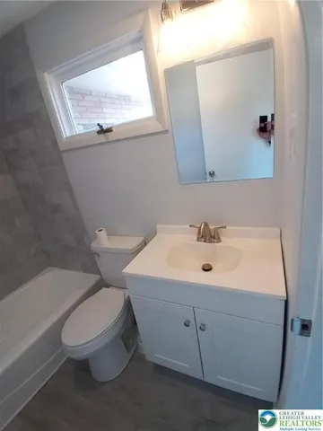 a white toilet sitting next to a bathroom sink