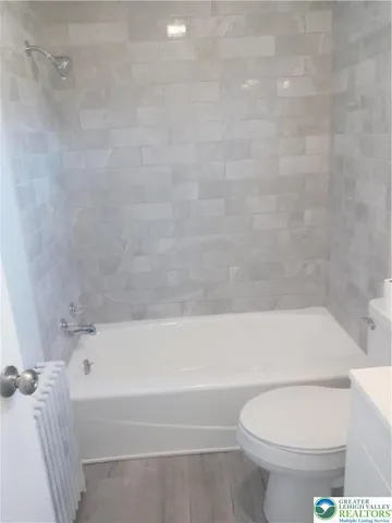a bathroom with a bathtub and a toilet