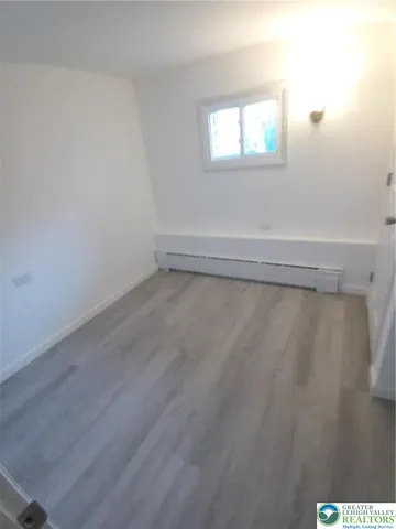a view of a room with a wooden floor
