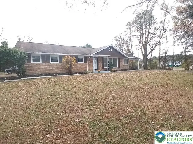 a front door view of a house with a yard