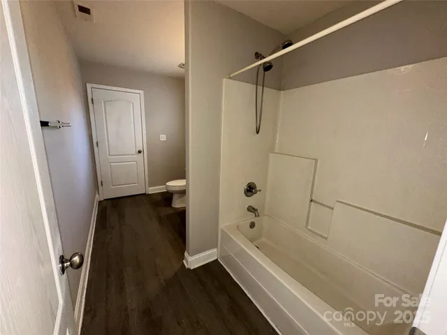 a bathroom with a bathtub a toilet and a shower