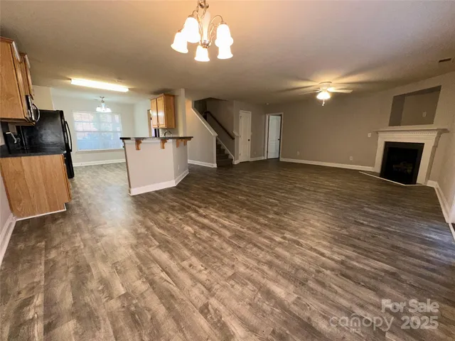a view of a kitchen with a sink and a fireplace