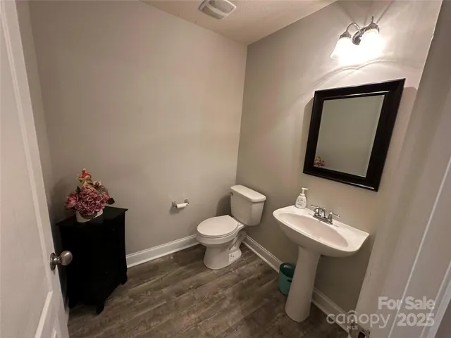 a bathroom with a sink toilet and mirror