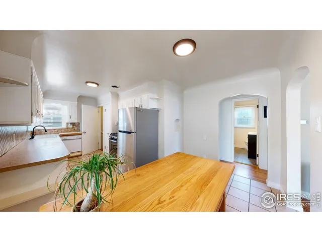 a room with a bed and a view of living room