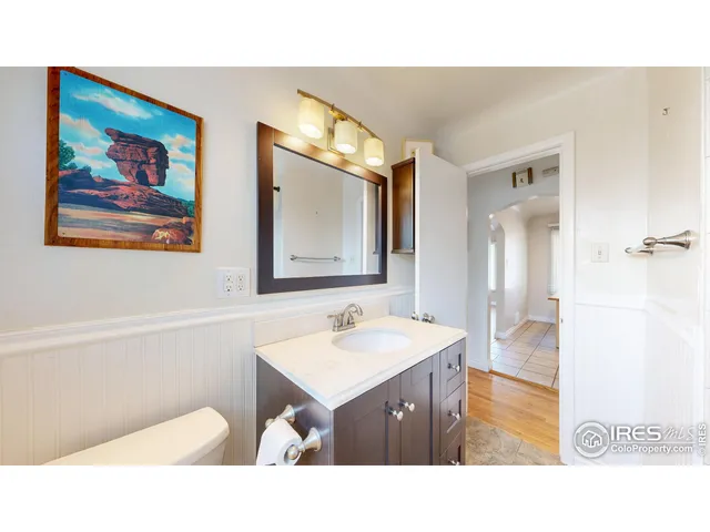 a bathroom with a sink a mirror and a vanity
