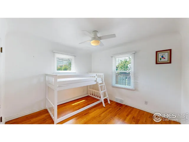 a living room with a bed furniture and a window