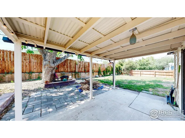 a backyard of a house with table and chairs