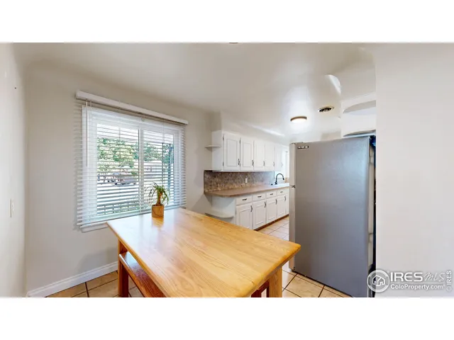 a kitchen with kitchen island a sink table and chairs