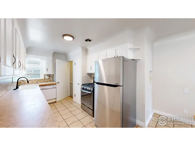 a bathroom with a sink a refrigerator and a sink