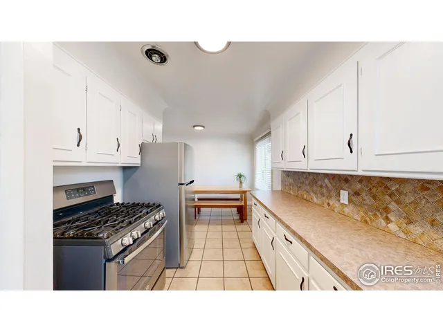 a kitchen with stainless steel appliances a stove a sink and cabinets